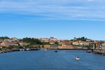 Fototapeta premium View of Porto city and Douro river and Dom Luis bridge. Porto, Vila Nova de Gaia, Portugal. Cityscape along the river