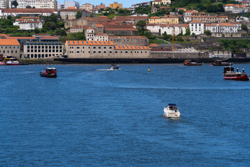 Obraz premium View of Porto city and Douro river and Dom Luis bridge. Porto, Vila Nova de Gaia, Portugal. Cityscape along the river