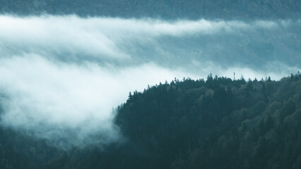 Moody Low Hanging Clouds Over Blue Green Trees. Misty Morning Cool Scene. Nature Landscape Wallpaper Background. Beautiful Scenic View. New England.