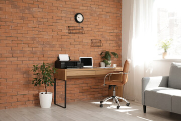 Interior of office with workplace, printer and plants