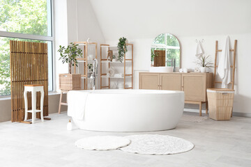 Stylish interior of modern bathroom with different houseplants