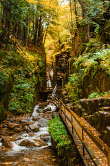 Flume Gorge Franconia Notch State Park Autumn Scenic Forest Trail Wooden Bridge and Stairs Cascading River in New Hampshire. Fall Foliage Season Wet