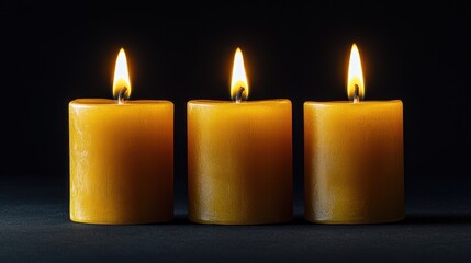 Three Burning Candles on a Black Background