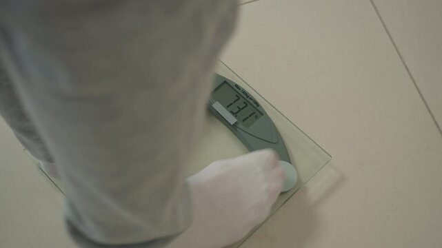 Close up male man legs feet stepping on floor scales measure kilograms weight loss diet overweight barefoot measuring body fat slimming fitness scale health bodycare wellbeing sportsman sport digital