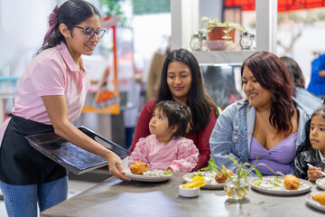 Latin american waitress serving traditional peruvian food to customers