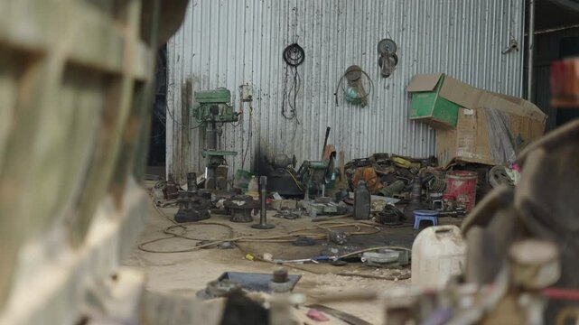 small dirty and messy humble family mechanic workshop in a rural area of vietnam