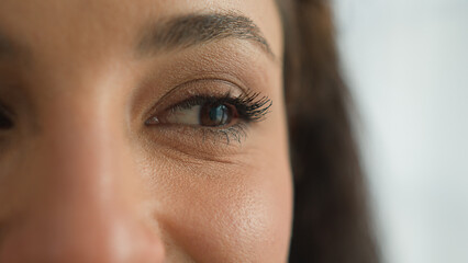 Close up woman brown eye make-up mascara female girl femininity beauty facial expressions blinking...