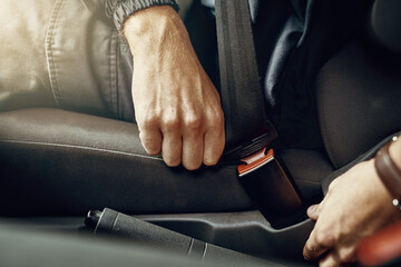 Person, hands and fasten seatbelt in car for safety or protection on accident with drive, travel and journey. Driver, closeup and vehicle or transportation for roadtrip with security for danger
