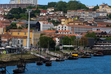View of Porto city and Douro river and Dom Luis bridge. Porto, Vila Nova de Gaia, Portugal. Cityscape along the river