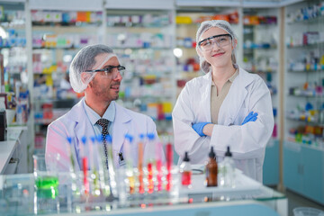 scientists perform experiments and record data. people arranges equipment with test tubes and chemicals for producing medicine and biochemistry. man hold tubes of chemical liquids and plant samples.