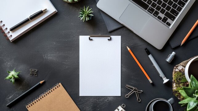 A desk with a laptop, notebook, and office supplies for productive work