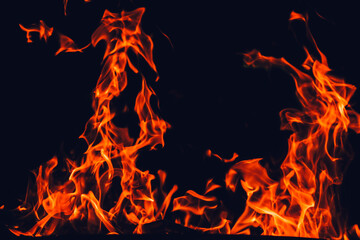 fiery wallpaper.Flame background. Fire texture on black background.Tongues of flame, sparks...