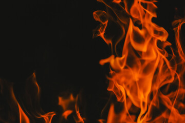 Flame background.Red black sparks and flames background.fiery wallpaper.Flames on a black background.flames and sparks in the dark