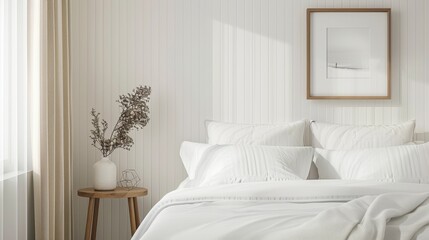 A minimalist bedroom with a white bed, a small bedside table, and a single framed photo