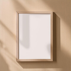 Blank wooden frame mounted on a beige wall with natural light casting shadows.