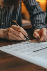 A person signing a document with a pen, a common office scene