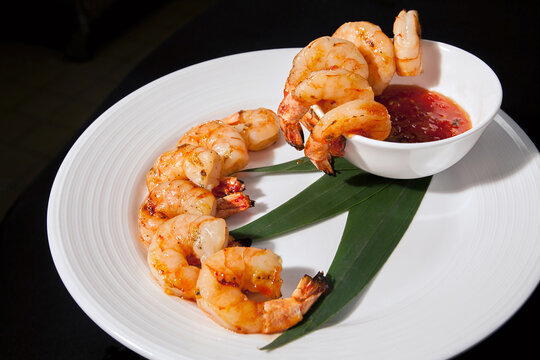Shrimp cocktail appetizer on a white plate with cocktail sauce