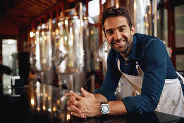 Portrait, happy and man brewer in supplier for quality control, manufacturing or production. Industry, job and business owner with machine for beer fermentation in factory for oktoberfest in Munich