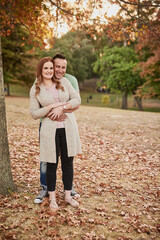 Outdoor, couple and portrait with hug for relationship, connection and bonding together on date. Happy people, woman and man with love for embrace, affection and commitment with smile in Canada