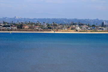 Mirror-like still water surface of Sail Bay and vacational houses, San Diego, Southern California