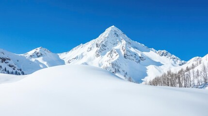 A stunning snow-covered mountain peak against a bright blue sky, showcasing the beauty of winter in a serene landscape.
