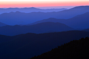 Layers in the landscape appear in the haze as the sunsets on the Great Smokey Mountains National Park in Tennessee