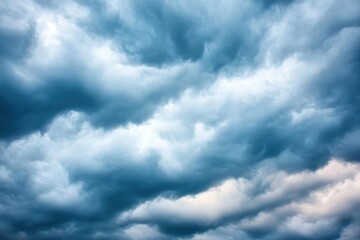 Fototapeta premium Dramatic sky with swirling clouds creating a vivid blue and white atmosphere, ideal for nature-themed projects and designs.