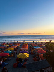 sunset at the beach , Umbrellas View Of Double Six Beach, Seminyak, Bali, Indonesia.	