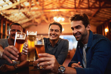 Friends, men and toast with beer at restaurant for social gathering, communication and relax in pub. Support, people and cheers with alcohol beverage for happy hour, celebration and reunion together
