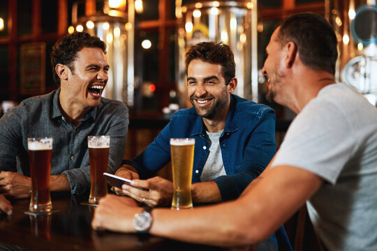 Men, laughing and relax with beer at pub for social gathering, communication and bonding on weekend. Friends, smile and conversation with alcohol beverage for happy hour, drinks or reunion together
