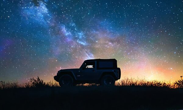 A jeep silhouetted against a breathtaking starry night sky, evoking adventure