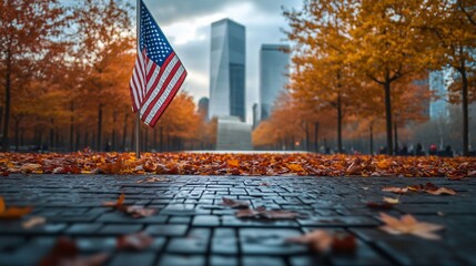 Ground Zero Memorial with an American flag and autumn leaves in the background