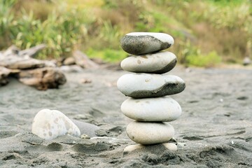 stack of zen stones on the black sand beach