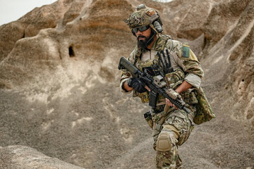 A group of military men in combat gear patrol in the middle of a desert and tropical jungle....