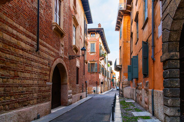 A deserted narrow street at dusk in the historic medieval Citta Antica old town of Verona, Italy.