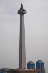 close up view of the building with the shape of a burning fire torch, close up view of the indonesian national monument.