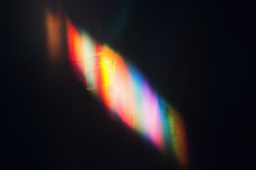 Rainbow light flare on the wall. Abstract wallpaper design.