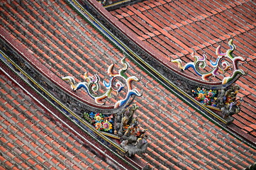 The vibrant dragon carvings on the rooftop of Taipei Baoan Temple highlight traditional Minnan...