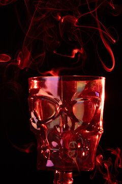 copa de calavera huesuda roja con humo alrededor