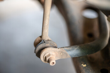A bent metal piece with a bolt on it
