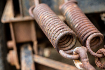 A rusty spring with a red and black design.