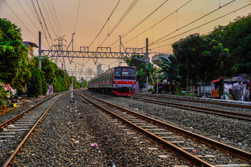 Obraz premium Modern electric passenger train entering the train station. Summer landscape in the background with photocopy blank rusng.