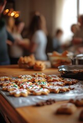A festive kitchen scene with Christmas cookies being decorated, blurred people baking in the background