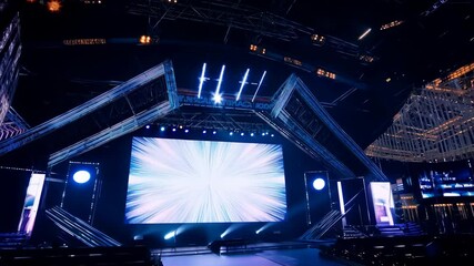 Exciting live presentation on stage at a modern venue in the evening, showcasing innovative technology and creative designs