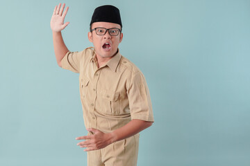 Angry Indonesian government worker man wearing khaki uniform doing slapping hand gesture.