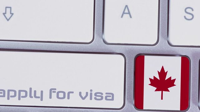 A computer, Canadian flag and Apply for Visa button 