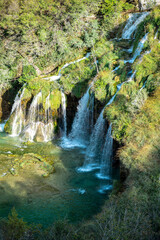 Fototapeta premium Plitvice Lakes National Park. Croatia. Big waterfalls. Nature travel background. Beautiful summer nature. Plitvice waterfalls in Croatia. Mountain streams flow into a lake with azure clear water.