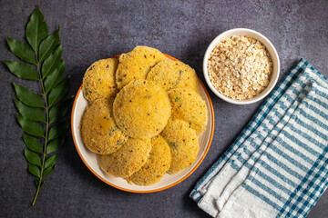 Oats Idli is a healthy, steamed South Indian breakfast made with oats, semolina, yogurt, and spices, offering a nutritious twist. Selective focus.
