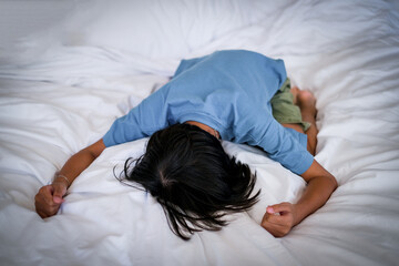 Crying girl, victim of bullying, abuse, violence, depressed patient, offering psychotherapy sitting on the bed. She was bullied, unhappy, upset, feel sick. Lonely concept.