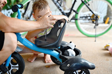 Kid boy repairing bicycle